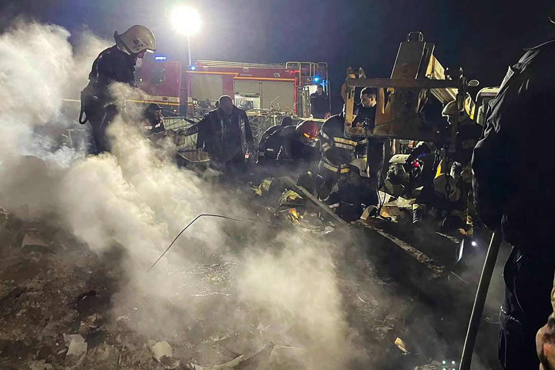Rescuers work at a site of a residential building damaged during a Russian drone strike in Vinnytsia Region