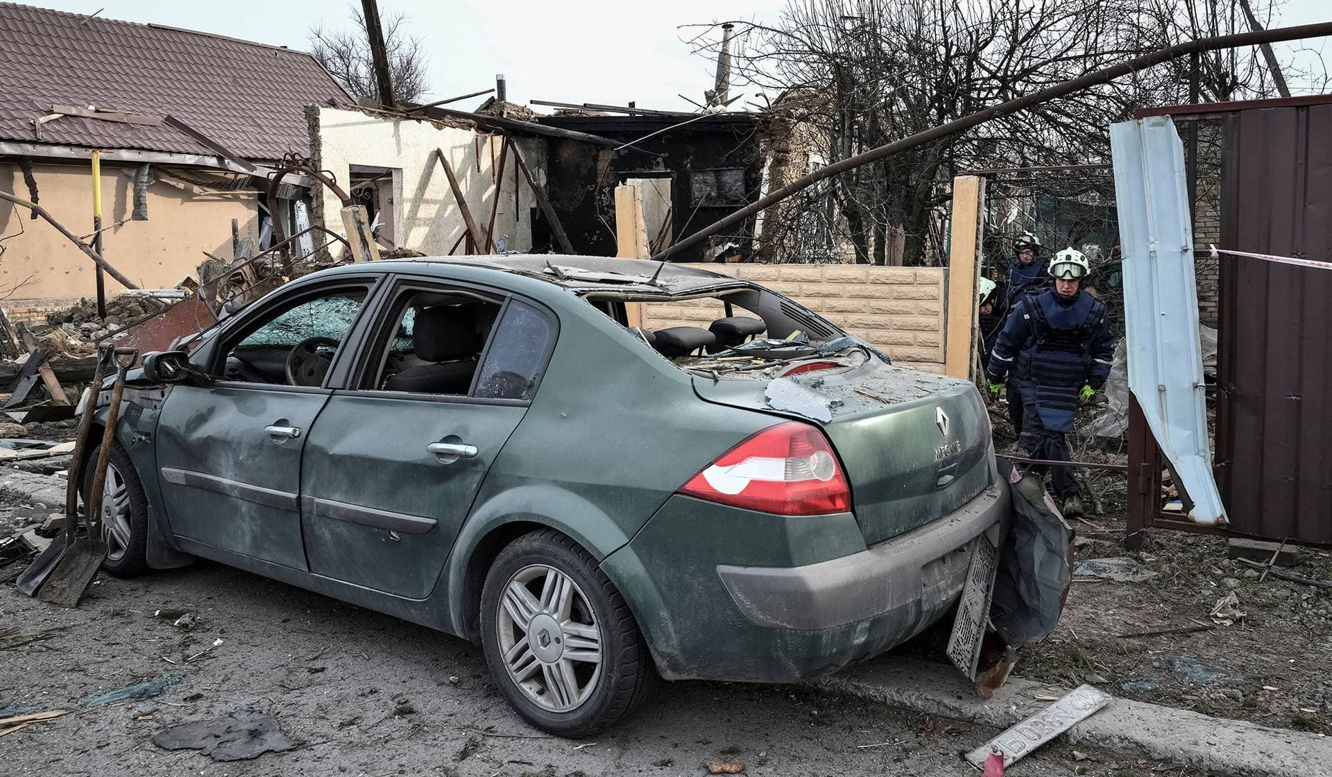 Rescuers work at the site of a building hit by a Russian drone strike in Zaporizhzhia
