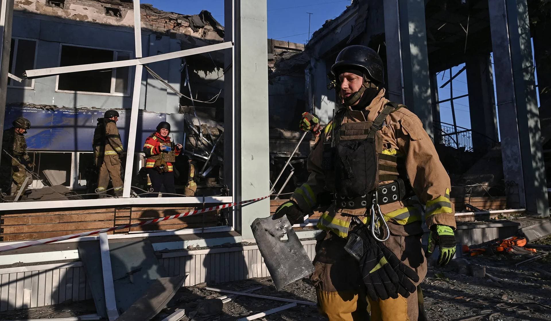 Rescuers and police officers work at the site of the Russian air strike in Zaporizhzhia