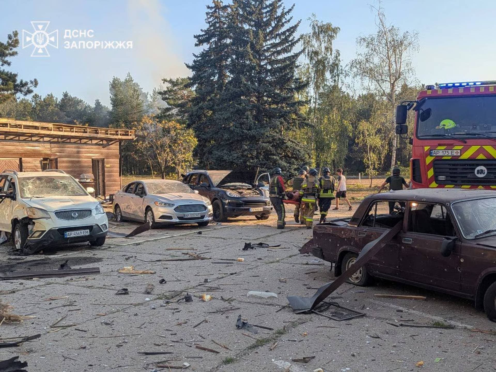 Rescuers evacuate a wounded resident at the site of a Russian military strike in Zaporizhzhia Region