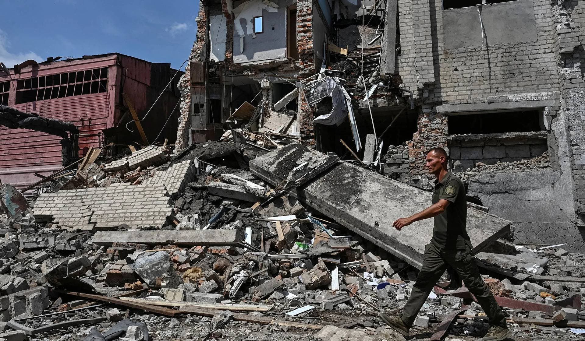 A serviceman walks at the site of the penal colony hit by a Russian air strike in Zaporizhzhia Region