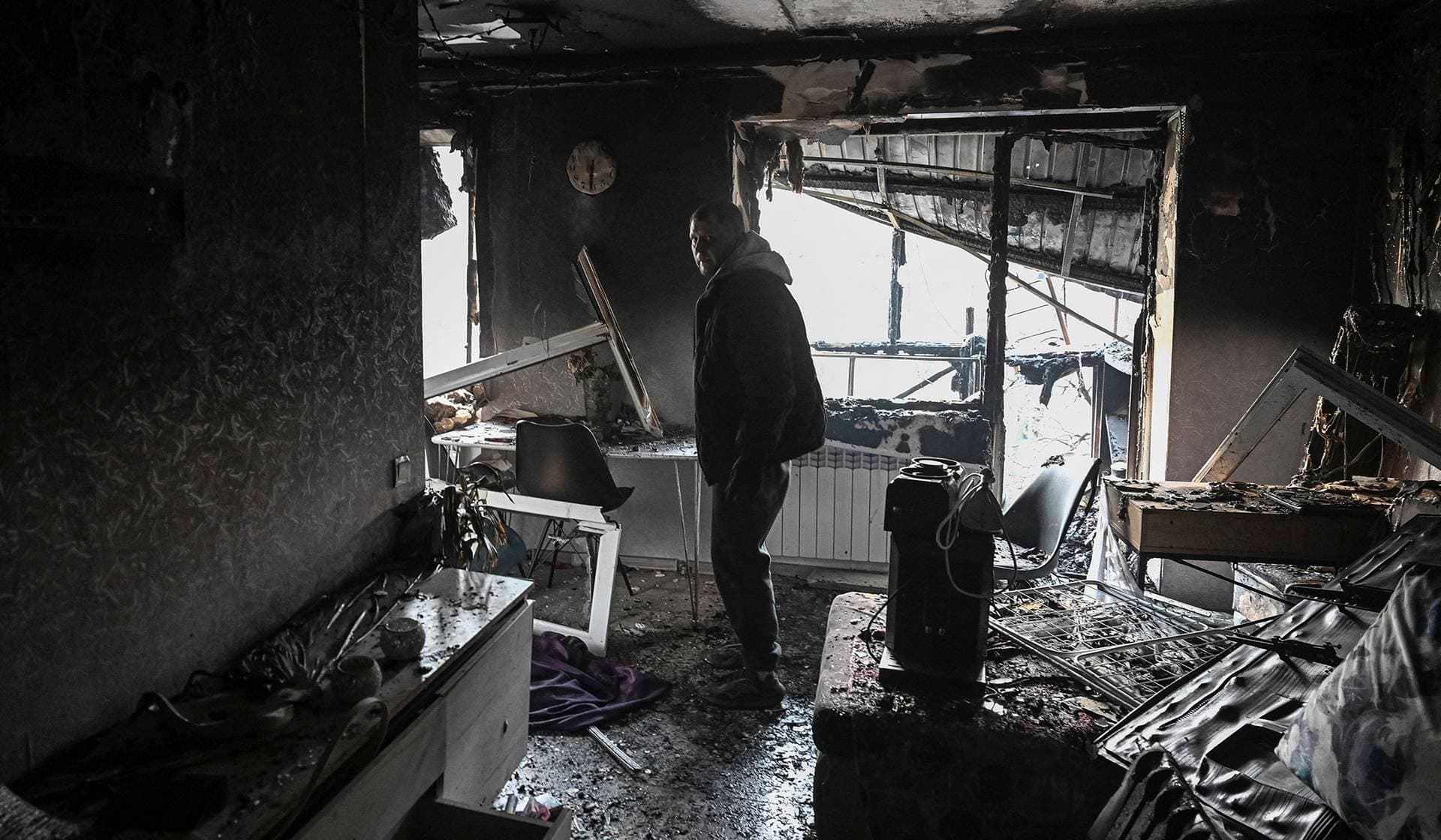 A resident visits his apartment in a building damaged by a Russian drone strike in Zaporizhzhia