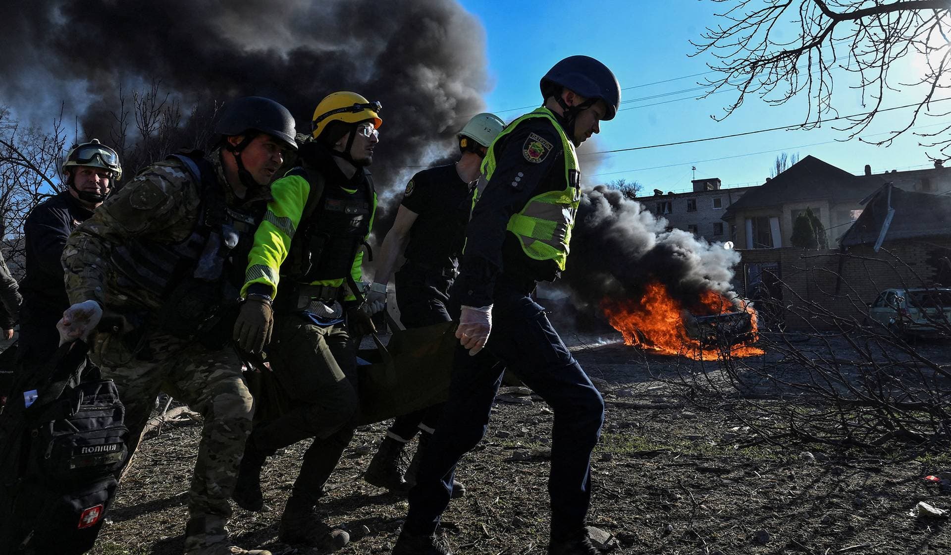 Emergency workers carry an injured woman at a site of a Russian missile strike in Zaporizhzhia