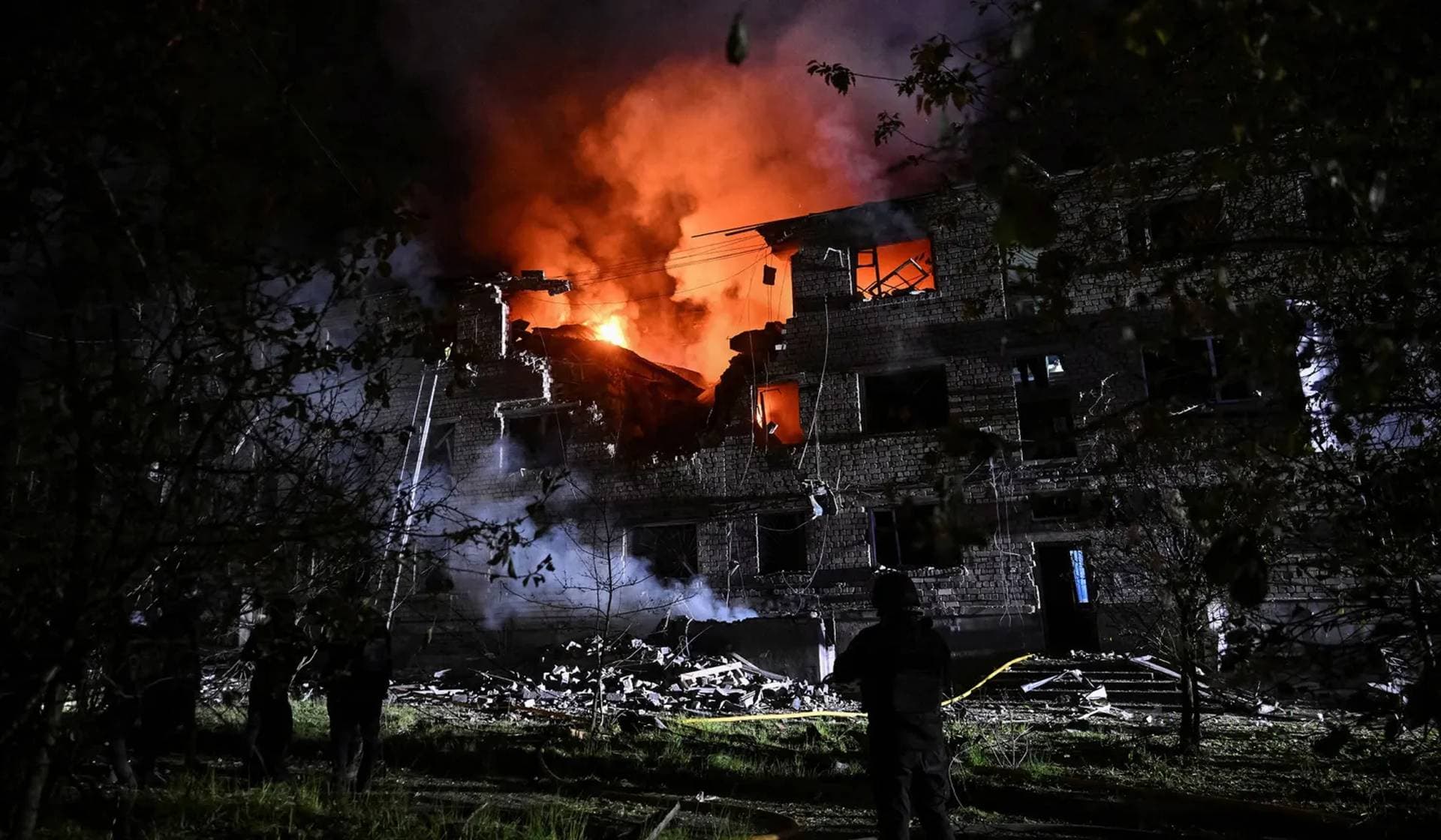 Rescuers work at the site of an apartment building hit by a Russian drone strike in Zaporizhzhia