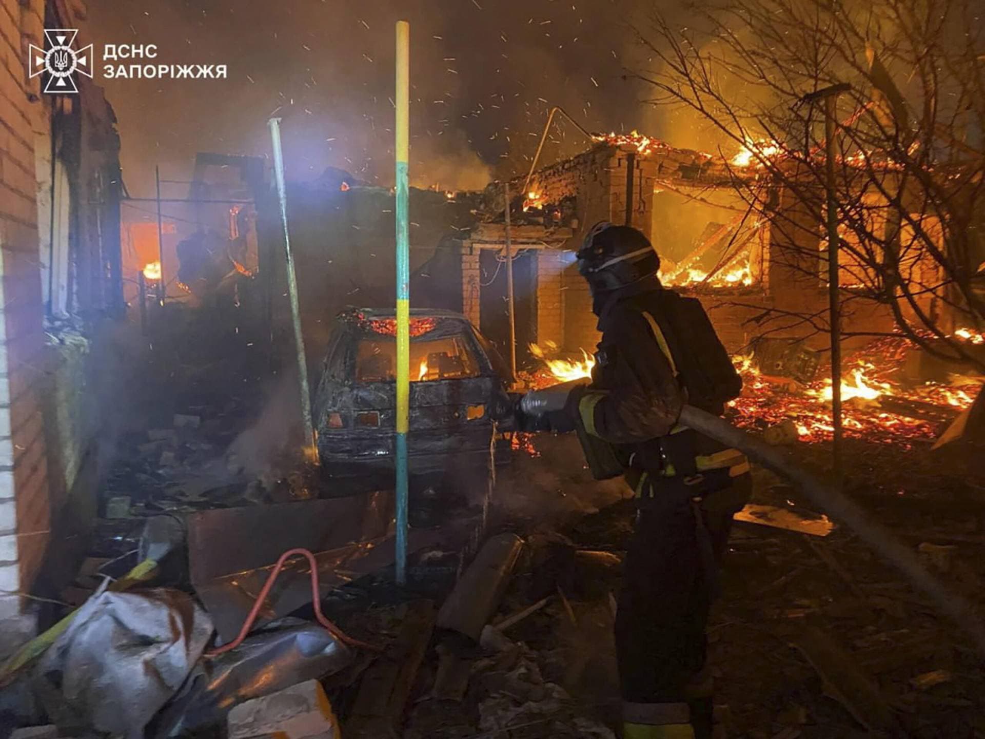 A firefighter works at the site of an apartment building hit during a Russian drone and missile strike in Zaporizhzhia