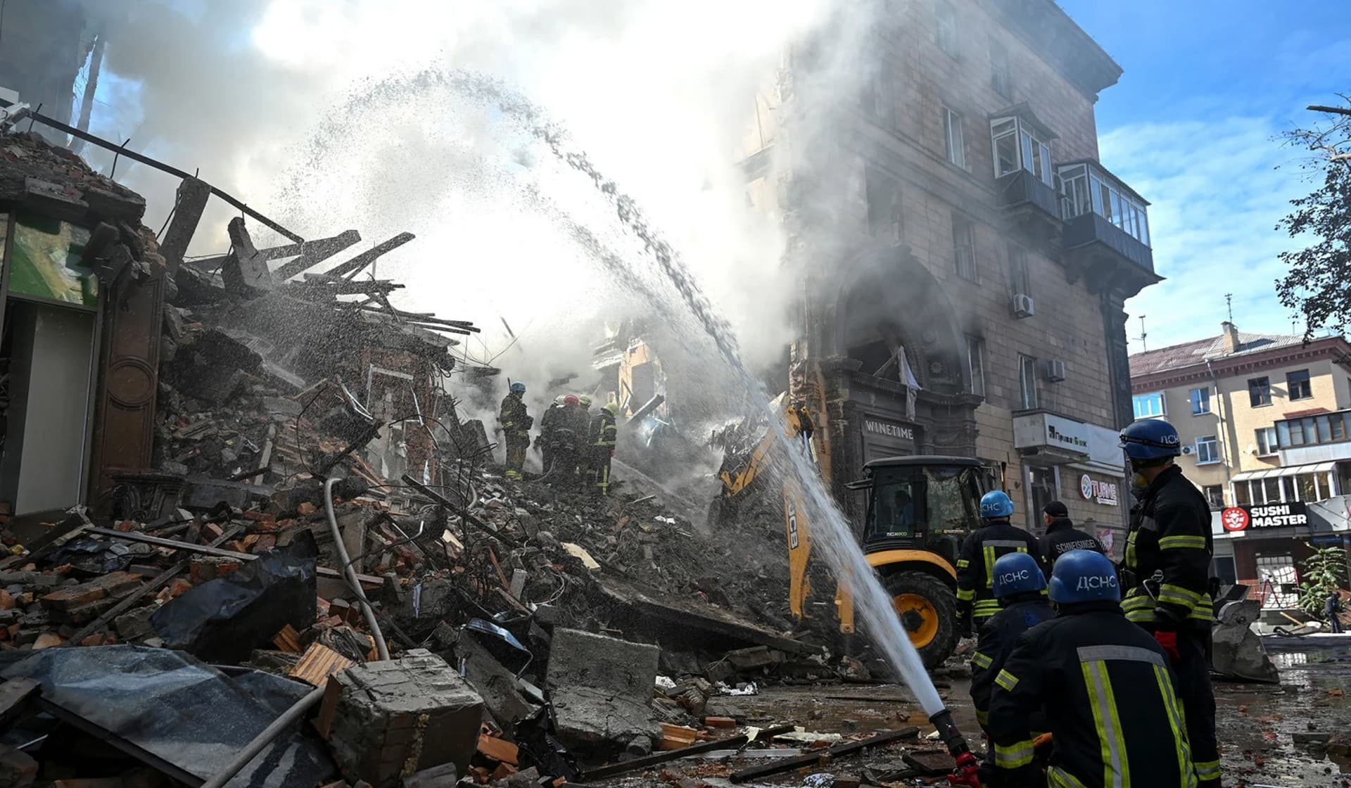Rescuers work at the site of a residential building heavily damaged by a Russian missile strike in Zaporizhzhia