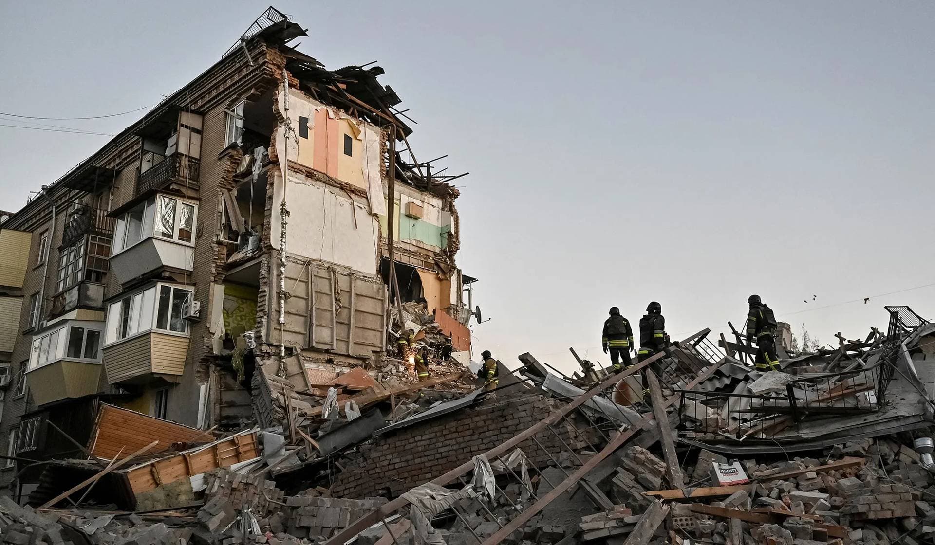 Rescuers work at a site of an apartment building hit by a Russian air strike in Zaporizhzhia