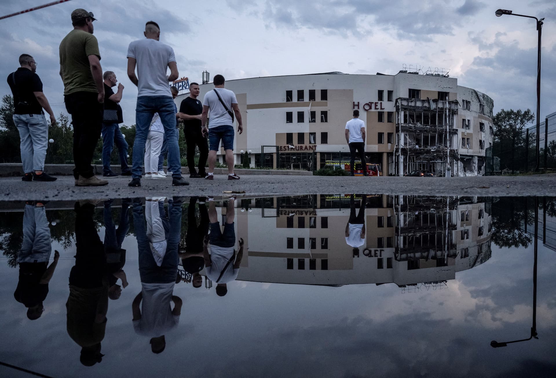 People stand near the site of a Russian missile strike in Zaporizhzhia
