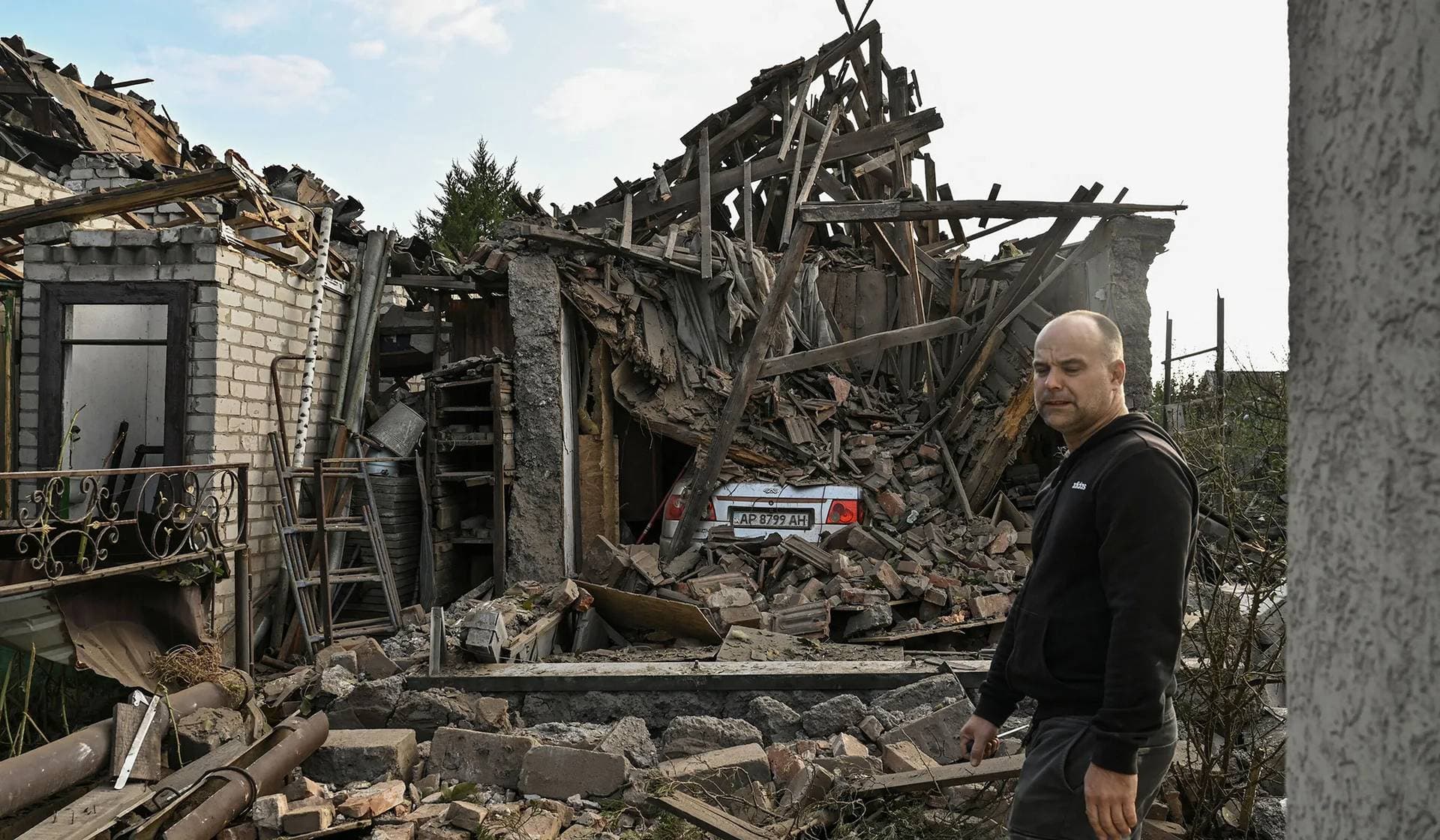 A man stands next to his house destroyed by a Russian air strike in Zaporizhzhia