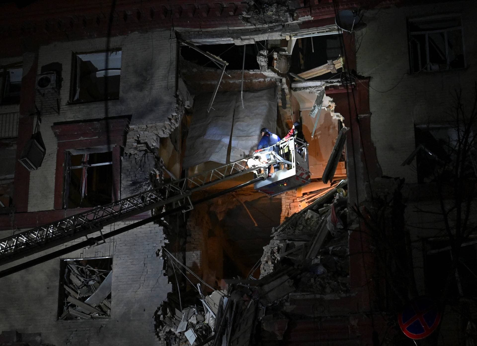 A rescuer works at a site of a residential building damaged by a Russian missile strike in Zaporizhzhia