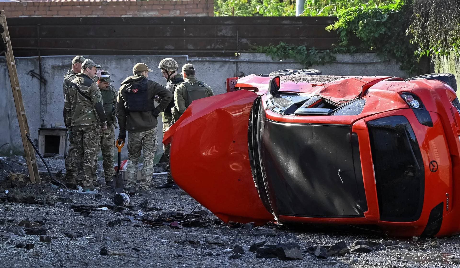 Police sappers work at the site of a Russian missile strike in Zaporizhzhia