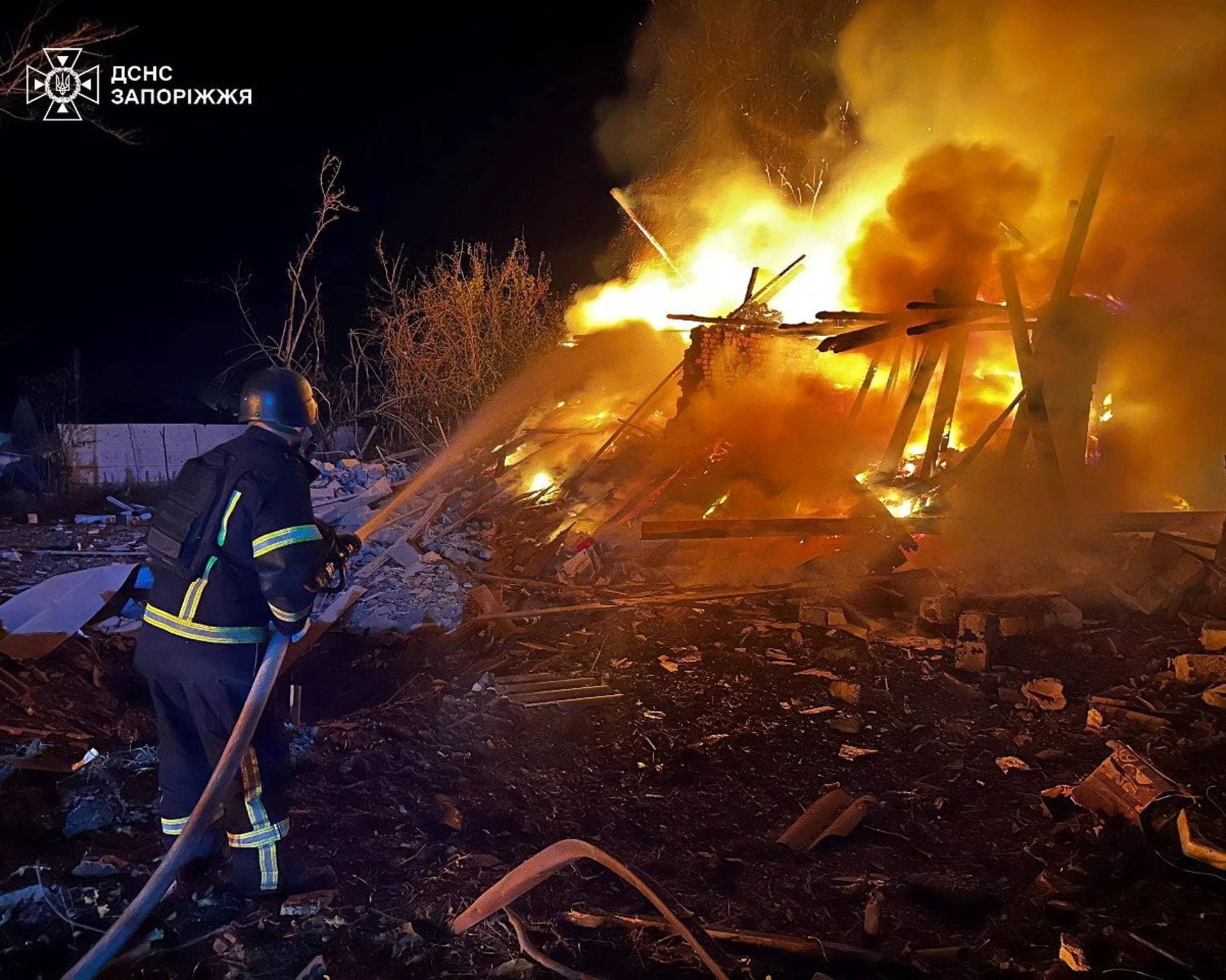 A firefighter works at the site of buildings hit during the Russian air strike in Zaporizhzhia